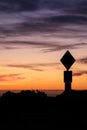 Road sign silhouette and colorful sunset Royalty Free Stock Photo