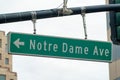 Road sign in silicon valley that says Notre Dame Ave in san jose california with green and white paint and arrow Royalty Free Stock Photo