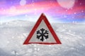 Winter driving - warning sign - risk of snow and ice Royalty Free Stock Photo
