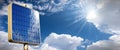 Road Sign with a Solar Panel Against a Blue Sky with Clouds and Sunbeams