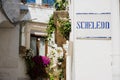 Road sign with street dialect name in a Puglia road