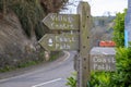 Road sign for tourists with directions to Village centre and Coast path Royalty Free Stock Photo