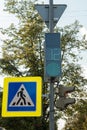 Road sign and traffic light on a street pole Royalty Free Stock Photo