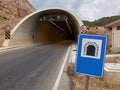 Road sign tunnell near the entrance of the motorway tunnell. Transport infrastructure and safety