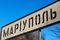 Road sign of the Ukrainian city Mariupol, Donetsk region, punched by bullets during the war, Ukraine Royalty Free Stock Photo