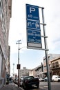 Road sign, warning and signage in street for parking with caution notification and blue square outdoor in city Royalty Free Stock Photo