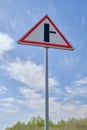 Road sign warning turn from main road blue sky background