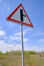 Road sign warning turn from main road blue sky background