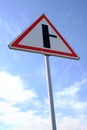 Road sign warning turn from main road blue sky background