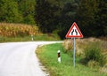 Road sign that warns drivers of constriction on the road