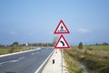 Road sign that warns drivers of upcoming crosswalk and sharp turn left Royalty Free Stock Photo
