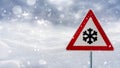 Road sign warns of snow and ice at road in winter Royalty Free Stock Photo