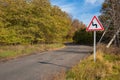 Road sign winding road in the countryside on an autumn sunny day Royalty Free Stock Photo