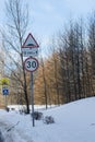 Road Sign on a winter day. Winter forest landscape behind