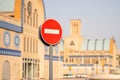 Road signs in the business center. Skyscrapers and construction. Symbol - move without stopping. Round road stop sign, on a pole Royalty Free Stock Photo