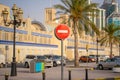 Road signs in the business center. Skyscrapers and construction. Symbol - move without stopping. Round road stop sign, on a pole Royalty Free Stock Photo