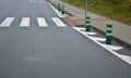 Road signs drawn on the road side. zebra where he must not stop and park. asphalt with the support of green plastic posts. These p