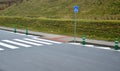 Road signs drawn on the road side. zebra where he must not stop and park. asphalt with the support of green plastic posts. These p