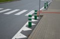 Road signs drawn on the road side. zebra where he must not stop and park. asphalt with the support of green plastic posts. These p