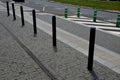 Road signs drawn on the road side. zebra where he must not stop and park. asphalt with support of green plastic posts. These post