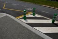 Road signs drawn on the road side. zebra where he must not stop and park. asphalt with support of green plastic posts. These post