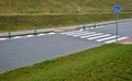 Road signs drawn on the road side. zebra where he must not stop and park. asphalt with the support of green plastic posts. These p