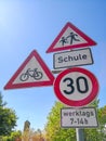 Road signs in front of school speed limit with german text means: school. on weekdays 7-14h