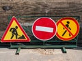 Road signs installed on a metal fence warn of repairs Royalty Free Stock Photo