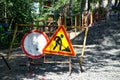 Road signs prohibiting travel to the site of excavation. Repair and replacement of underground utilities in the city