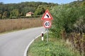 Road signs that shows maximum speed of 40 kilometers per hour and signa that warns drivers on sharp curve ahead Royalty Free Stock Photo