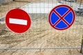 Road signs on street repair fence