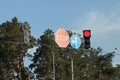 Road signs and traffic lights hang on wires above the road Royalty Free Stock Photo