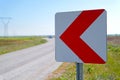 Road signs warning drivers about ahead dangerous curve and blurred car in background Royalty Free Stock Photo