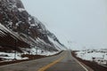 Road skirting snow-covered mountains in the Andes