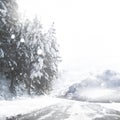 Road, snow covered and storm in nature, cold and ice weather conditions with dangerous to travel. Woods, winter and Royalty Free Stock Photo