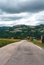 Road and Solar pannels in a remote area in the mountains on background. Small solar power plants. Rainy day. The clouds.