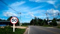 road with speed limit and transmission tower sign Royalty Free Stock Photo