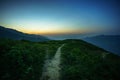 Road on spine and the top of the mountains covered with greenery with gentle valleys at dawn