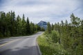 Rocky Mountains. asphalt mountain road on a sunny day. Road with yellow markings. Empty highway in Journey Royalty Free Stock Photo