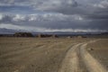 A road in the steppe overlooking the mountains in Mongolia. Royalty Free Stock Photo