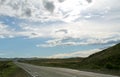 Road in steppe under a blue sky with white clouds Sayan mountains Siberia Russia Royalty Free Stock Photo