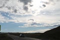 Road in steppe under a blue sky with white clouds Sayan mountains Siberia Russia Royalty Free Stock Photo