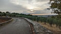 Road with stone fences during dramatic sunset Royalty Free Stock Photo