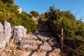 Road with stone steps on top of a mountain to Temple of Jupiter Anxur or Tempio di Giove Anxur, ancient ruins, on top of Pisco Royalty Free Stock Photo