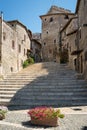 A road between the stone walls of Sermoneta, little medieval town in the Lazio region. ItalyLatina, Lazio region, a Royalty Free Stock Photo