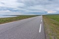 The road stretches into the distance on a background of green me Royalty Free Stock Photo