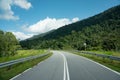 Road and summer mountain range landscape with green grass forest, blue sky, natural outdoors travel background, cloudy day, asphal Royalty Free Stock Photo