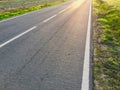 Sunlight reflected off asphalt, straight road leading into the distance Royalty Free Stock Photo