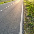 Sunlight reflected off asphalt, straight road leading into the distance Royalty Free Stock Photo