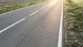 Sunlight reflected off asphalt, straight road leading into the distance Royalty Free Stock Photo